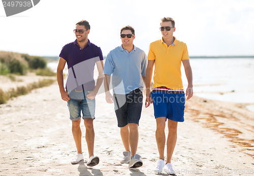 Image of group of friends walking on the beach