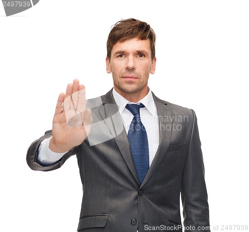 Image of attractive buisnessman making stop gesture