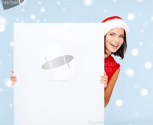 Image of woman in santa helper hat with blank white board