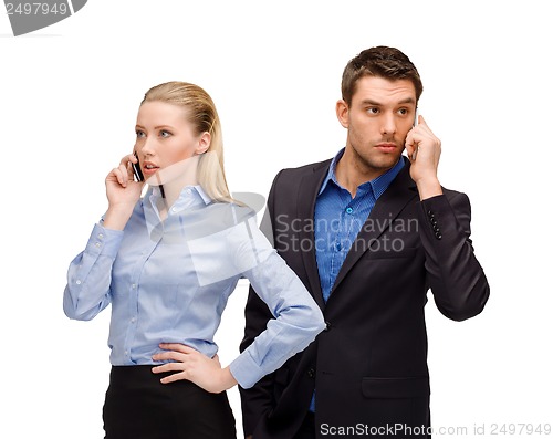 Image of woman and man with cell phones calling