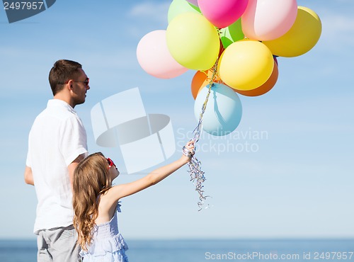 Image of father and daughter with colorful balloons