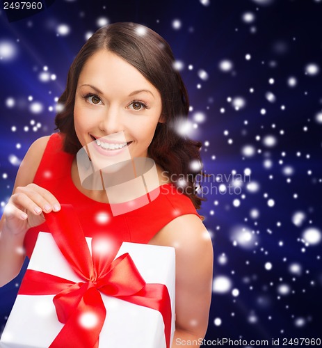 Image of smiling woman in red dress with gift box