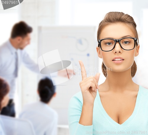 Image of attractive student wearing glasses in college