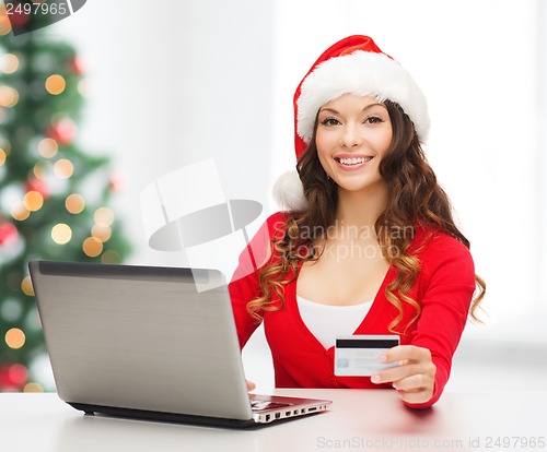 Image of santa helper woman with laptop and credit card