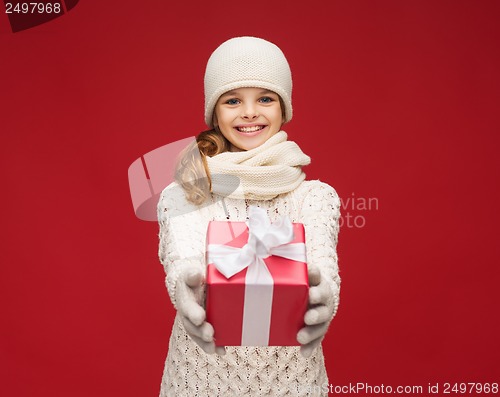 Image of girl in hat, muffler and gloves with gift box