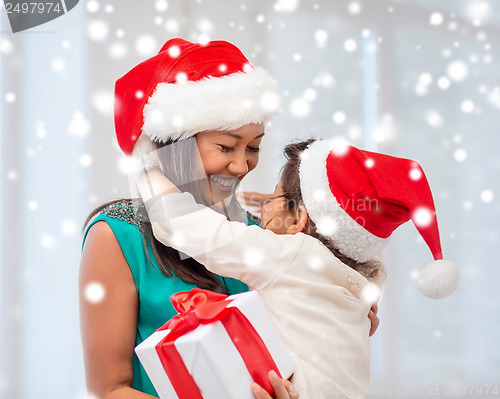 Image of happy mother and child girl with gift box