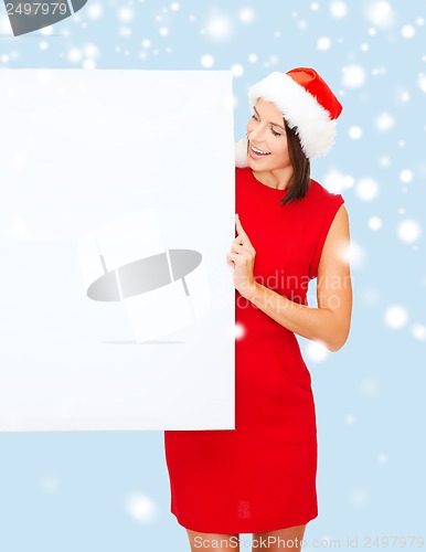 Image of woman in santa helper hat with blank white board