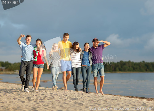 Image of group of friends having fun on the beach