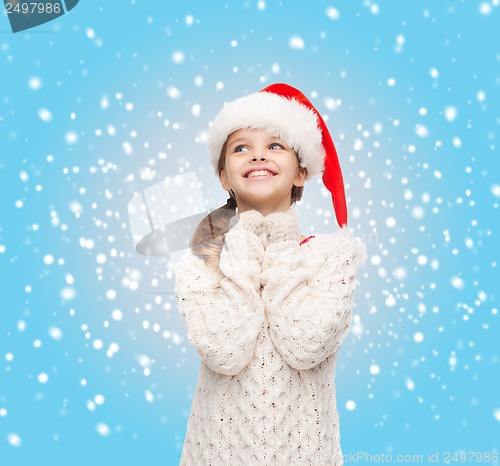 Image of dreaming girl in santa helper hat