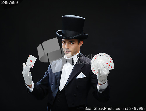 Image of magician showing trick with playing cards