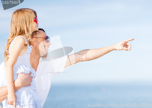 Image of happy father and child in sunglasses over blue sky