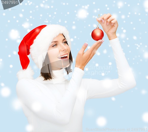 Image of woman in santa helper hat with christmas ball