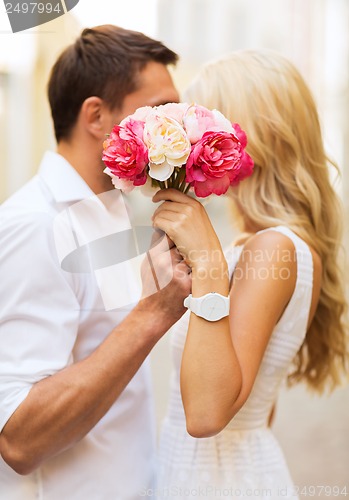 Image of couple with flowers in the city