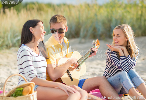 Image of group of friends having fun on the beach