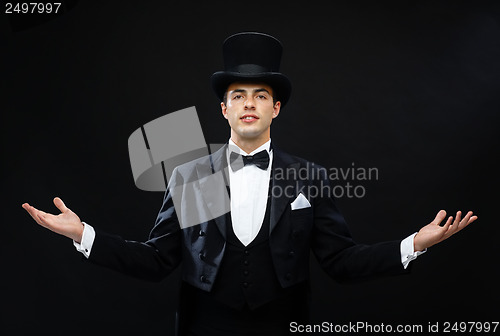 Image of magician in top hat showing trick