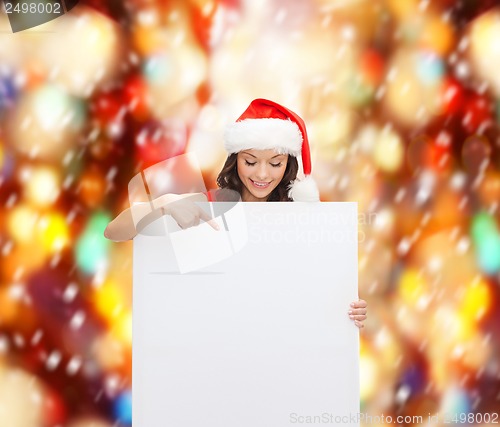 Image of woman in santa helper hat with blank white board