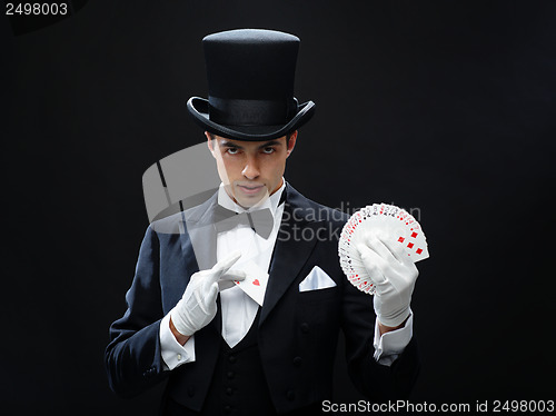 Image of magician showing trick with playing cards