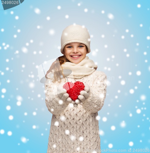 Image of girl in winter clothes with small red heart