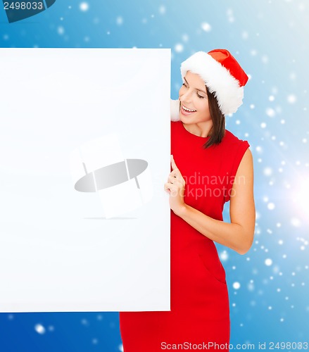 Image of woman in santa helper hat with blank white board