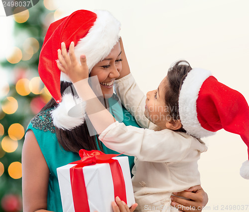 Image of happy mother and child girl with gift box