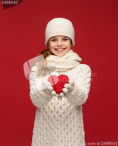 Image of girl in winter clothes with small red heart