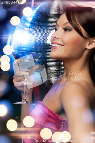 Image of woman with cocktail and disco ball