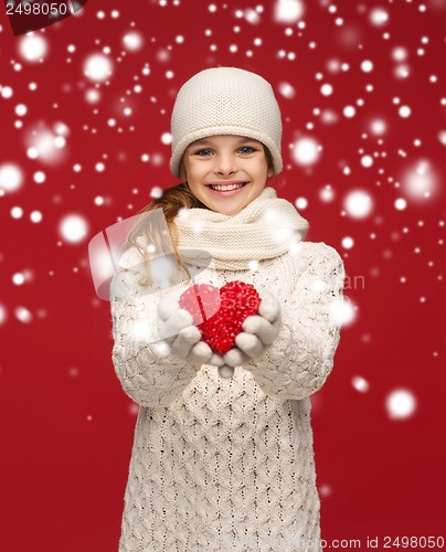 Image of girl in winter clothes with small red heart