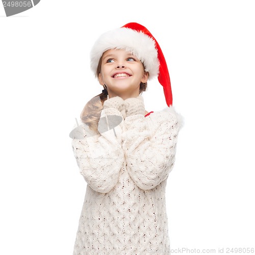 Image of dreaming girl in santa helper hat