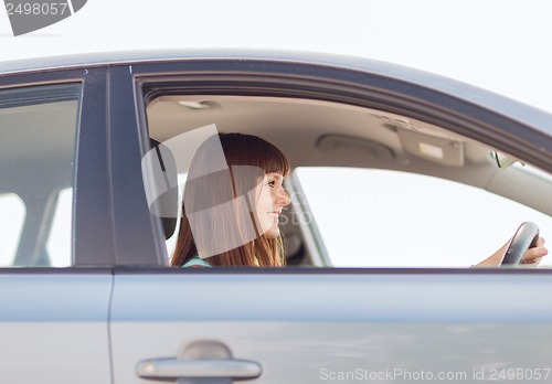 Image of happy woman driving a car