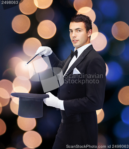 Image of magician in top hat with magic wand showing trick