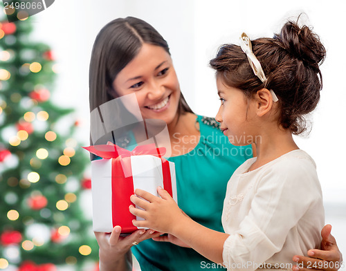 Image of happy mother and child girl with gift box