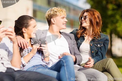 Image of students looking at smartphones and tablet pc