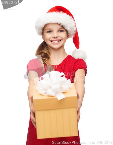 Image of smiling girl in santa helper hat with gift box