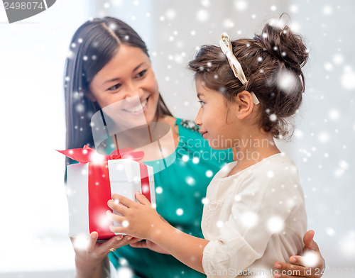 Image of happy mother and child girl with gift box