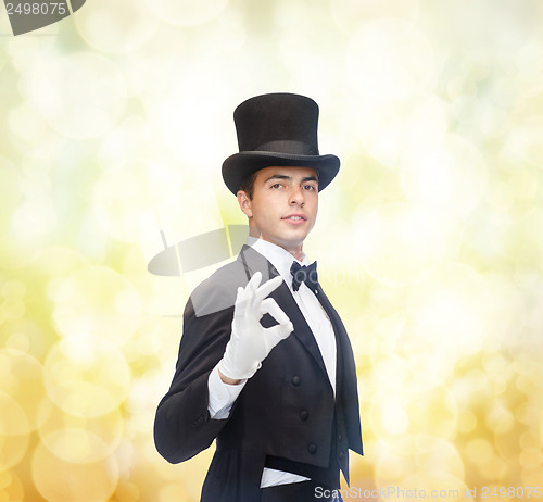 Image of magician in top hat showing trick