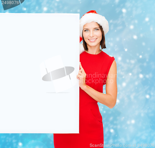 Image of woman in santa helper hat with blank white board