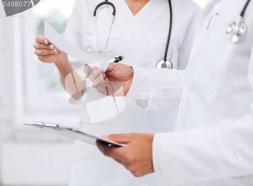 Image of two doctors writing prescription