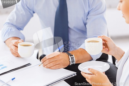 Image of man and woman discussing something in office