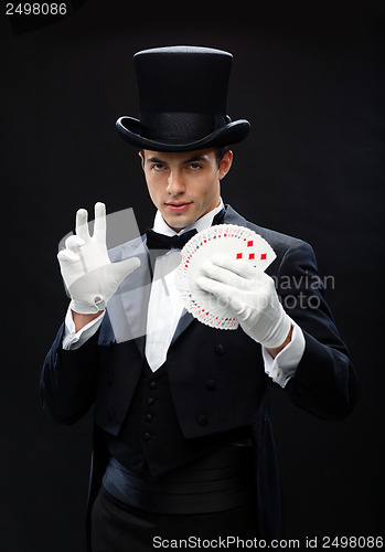 Image of magician showing trick with playing cards