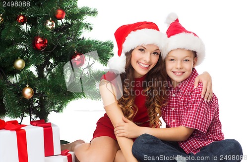 Image of happy mother and child boy with gift boxes