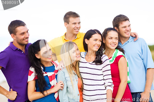 Image of group of friends having fun on the beach