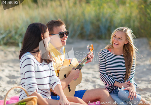 Image of group of friends having fun on the beach