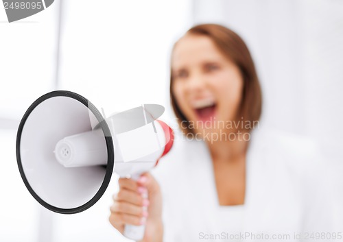 Image of strict businesswoman shouting in megaphone