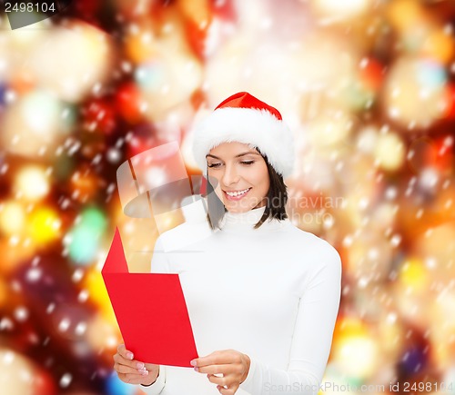 Image of woman in santa helper hat with blank red postcard