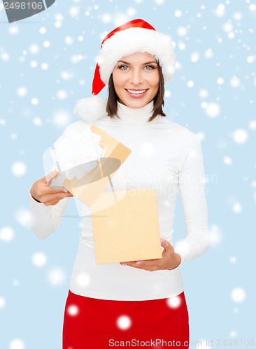 Image of smiling woman in santa helper hat with gift box