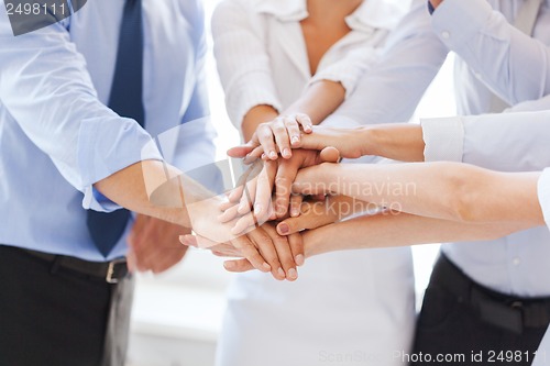 Image of business team celebrating victory in office