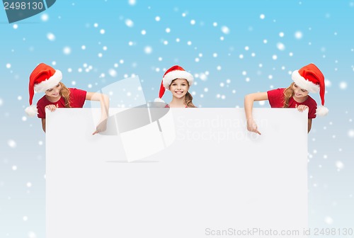 Image of children in santa helper hats with blank board