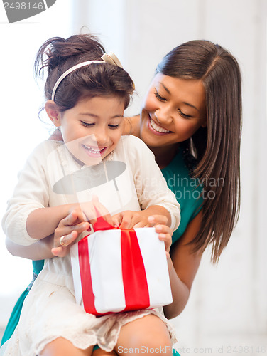 Image of happy mother and child girl with gift box