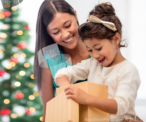 Image of happy mother and child girl with gift box