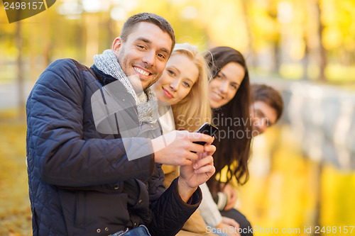 Image of group of friends having fun in autumn park